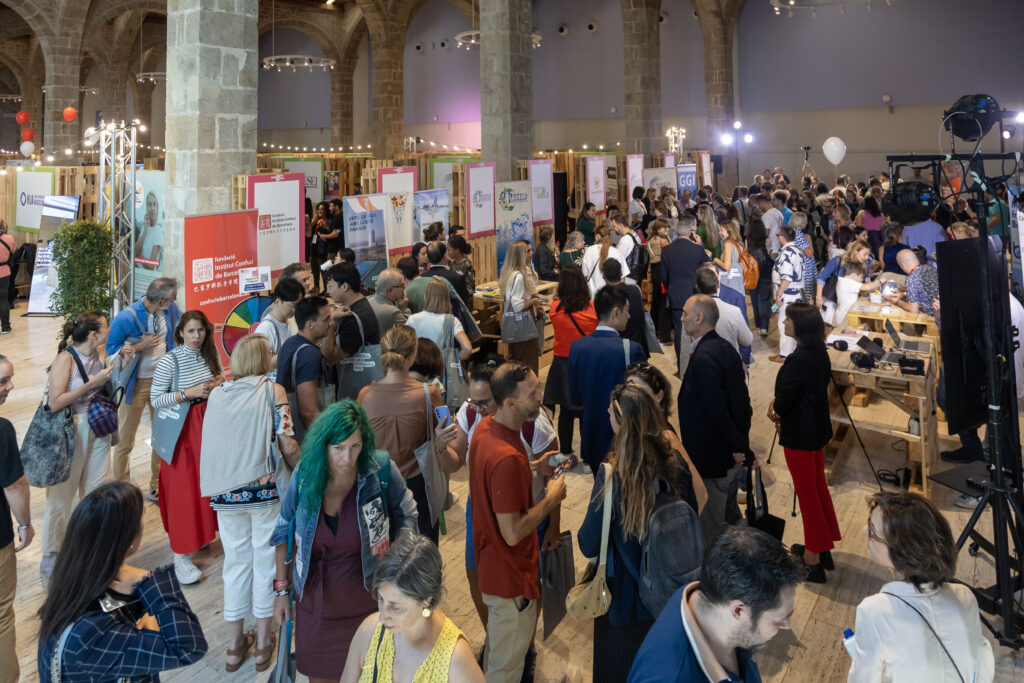 Crowds engaging with exhibitors at Barcelona International Community Day trade fair