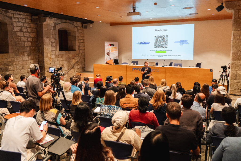 Speaker addressing a full auditorium at Barcelona International Community Day